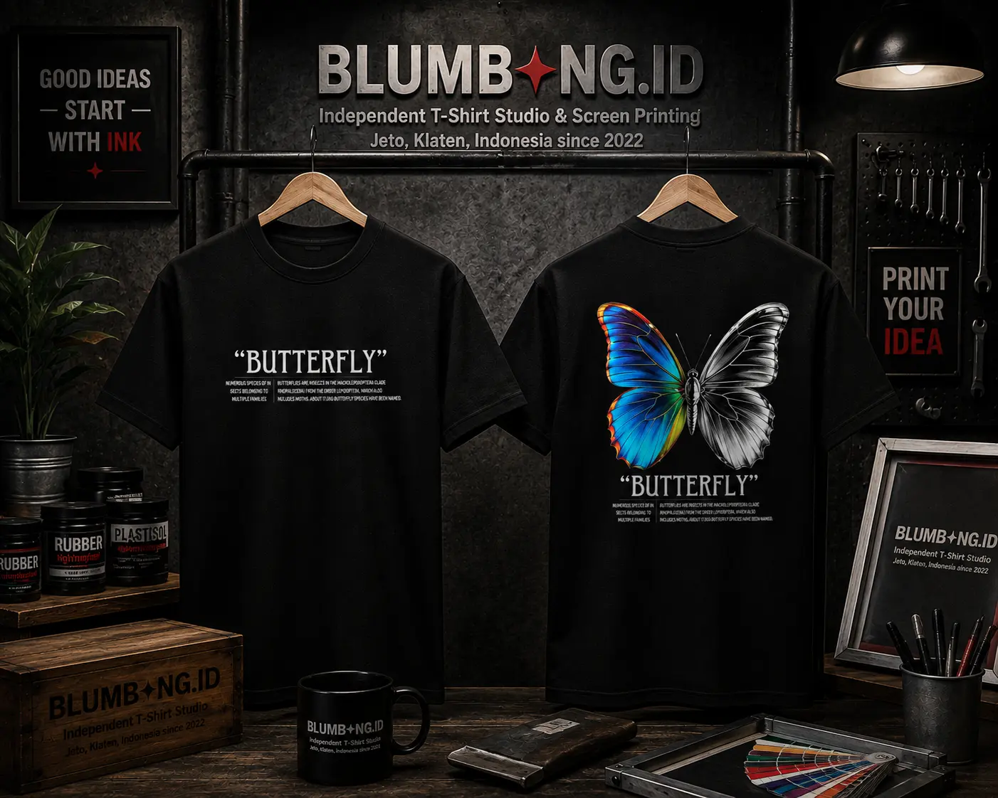 Kaos hitam Butterfly untuk Hanif and Friends, bagian depan tulisan Butterfly dengan keterangan taksonomi kecil, bagian belakang ilustrasi kupu-kupu terbelah dua — sayap kiri biru metalik realistis, sayap kanan hitam putih sketsa ilmiah, sablon DTF katun combed 30s